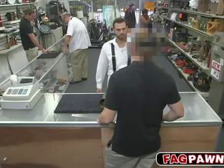 Dude blows a putz behind counter in a shop